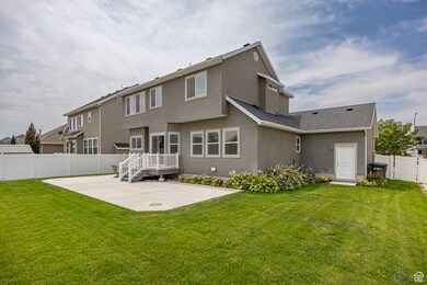 Back of house with a patio, stucco siding, a fenced backyard, and roof with shingles