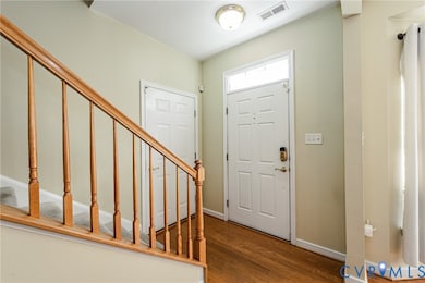 Entryway featuring hardwood / wood-style floors and stairs