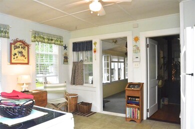 Kitchen looking onto the 3 season porch (to the le