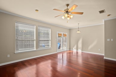 Spare room with wood-type flooring, a ceiling fan