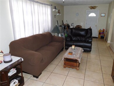Living room, and dinette in the back behind leathe