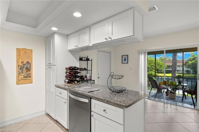 Living room with light tile patterned floors and a