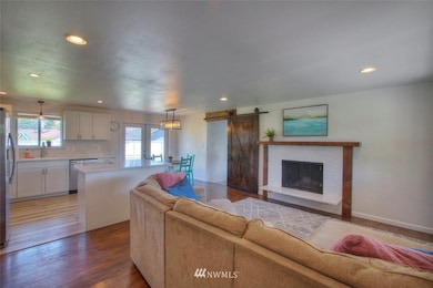 Cozy fireplace with Cambria Quartz finish. The barn door leads you to the large bonus room (4th bedroom?, office?) with adjacent 3/4 bathroom.