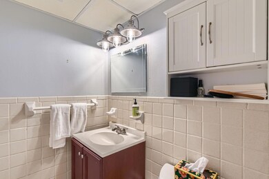 Bathroom featuring vanity, a wainscoted wall, and