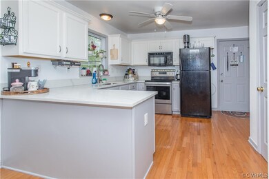 Kitchen with white cabinets, light wood-type floor