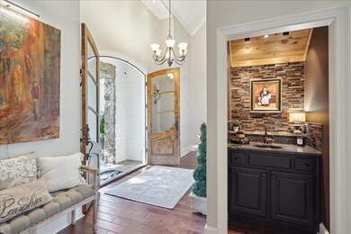 Foyer with lofted ceiling, indoor wet bar, dark wo