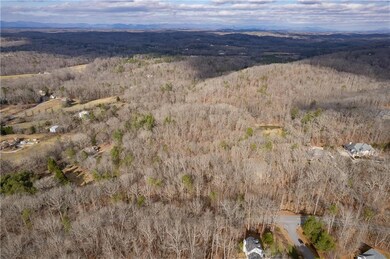 Aerial view of property's location with a forest a