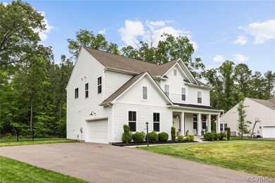 View of front facade with a front lawn, a garage,