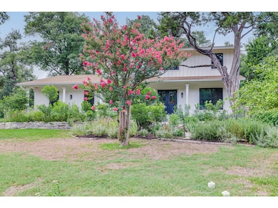 View of front of house with a porch, a front lawn, and brick siding