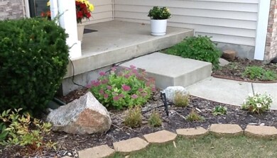 Plantings at the front porch welcome your guests.