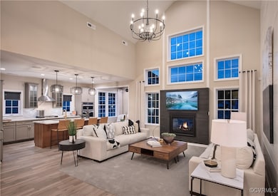 Living room with an inviting chandelier, high vaul
