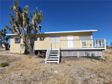 Rear view of house featuring a wooden deck
