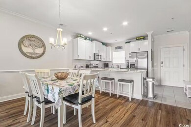 Dining area featuring crown molding, dark wood-typ