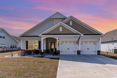 View of front of home with a yard, central AC, a g