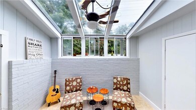 Sunroom is bright and airy, laundry is located through the door to the right