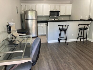 Kitchen featuring dark countertops, appliances wi