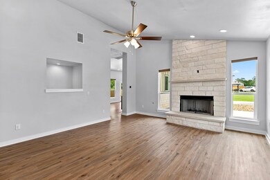 Unfurnished living room featuring wood finished f