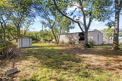 back corner lot featuring 1500 sf shop with drive-thru access on to accommodate boat storage or other large equipment