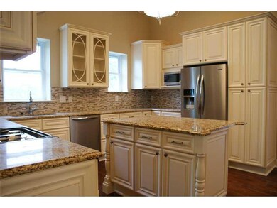 Kitchen. The kitchen has oversized cabinetry, a gl