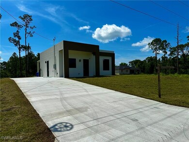 View of front facade with concrete driveway, a fro