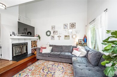 Hardwood floored living room featuring a towering