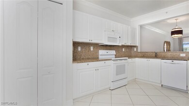 Kitchen featuring white appliances, light tile pat
