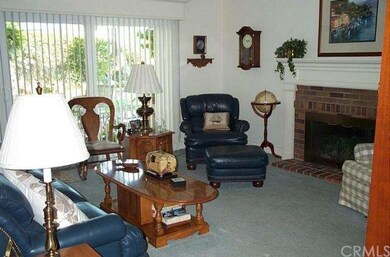 FAMILY ROOM WITH A COZY FIREPLACE.
