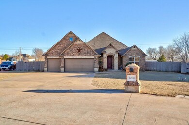 French provincial home featuring a garage, drivewa