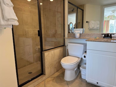Full bath featuring vanity, a shower stall, toilet
