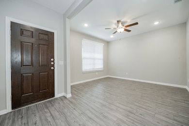 Entryway with a ceiling fan, light wood-type flooring, and recessed lighting