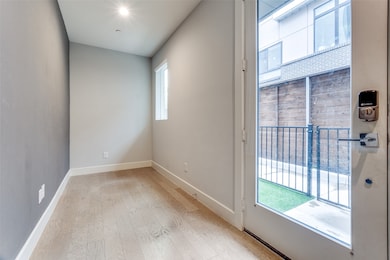 Empty room featuring light wood-type flooring and baseboards