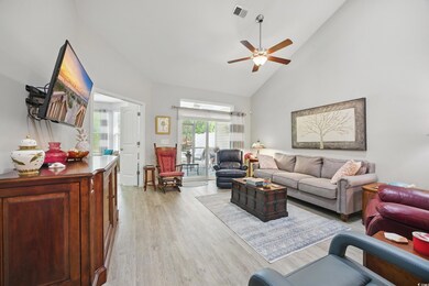 Living room featuring high vaulted ceiling, light 