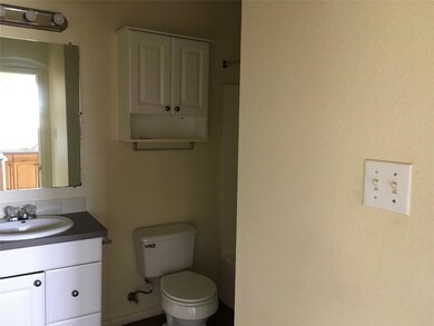 Bathroom featuring toilet, walk in shower, vanity