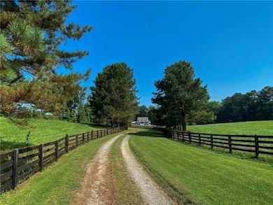 View of dirt / gravel road with a view of rural / pastoral area