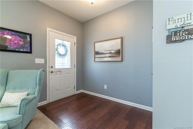 Welcoming entrance features hardwood floors & beau