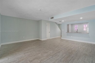 Spacious living room/ dining area. Door to left is