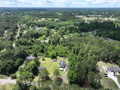 Aerial view featuring a wooded view