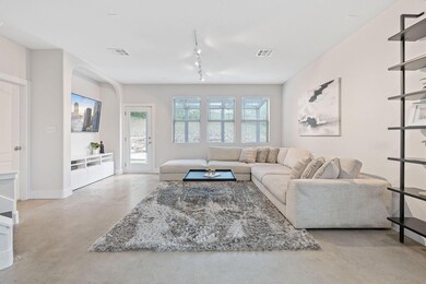 Living area with rail lighting, visible vents, ba