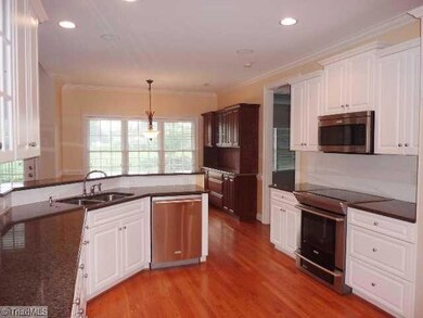 Kitchen. Open and airy with granite counters and up-to-date stainless appliances.