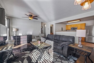 Living room with ceiling fan and hardwood / wood-s