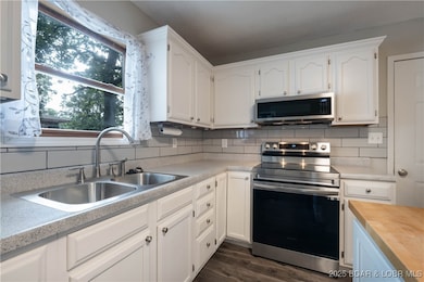Stainless Appliances w/ Tiled Backsplash