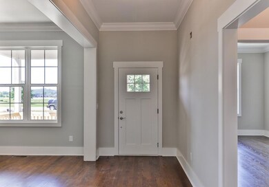 Beautiful wood trim. To the left is the dining room, and to the right is the office and a full bath