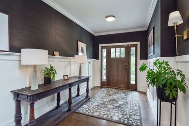 Spacious foyer with custom millwork and one of man