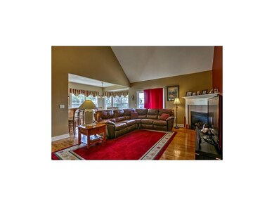 Living room with vaulted ceilings, corner fireplac