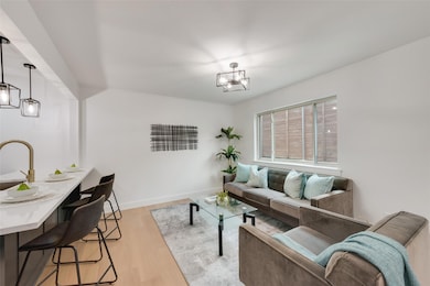 Living room with light hardwood / wood-style floor