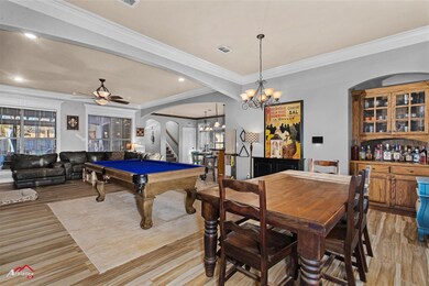 Family room room featuring ceiling fan with notabl