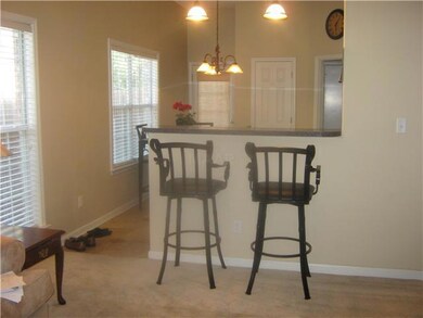 Breakfast bar in kitchen compliments this floor pl