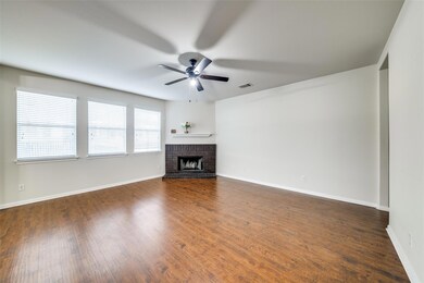 Unfurnished living room with ceiling fan, a firep