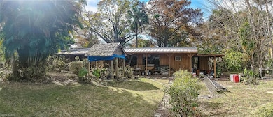 Back of house with a lawn