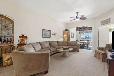 Living room with light carpet and ceiling fan with